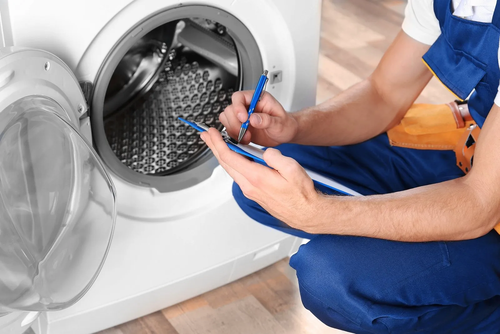 young-female-janitor-cleaning-office-with-various-cleaning-equipment.jpg